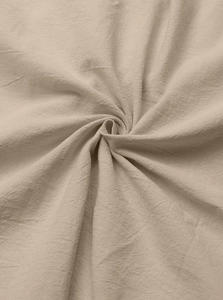 Macro shot of natural cotton linen fabric texture showing detailed weave and beige fiber