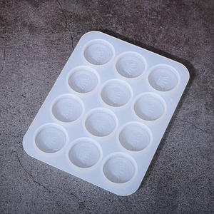 Macro detail of a 12-cavity silicone mold featuring intricate crown patterns for DIY resin