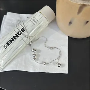 Detailed view of S925 sterling silver ball bracelet with snake chain in lifestyle setting