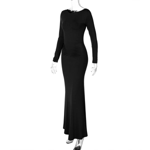 Detail of slim-fit long-sleeve black dress showing ruched waist and side pleated texture