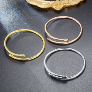 Three colors twisted cable wire open bangles set in gold silver and rose gold finish.