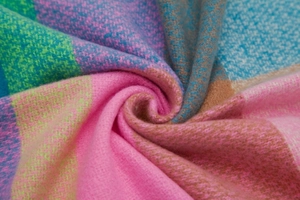Macro shot of thick rainbow plaid scarf showing soft texture and colorful woven details