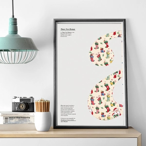 Detail of Christmas poster in black frame featuring Santa motifs and Spanish typography