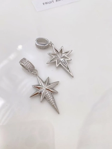 Detail of silver octagonal star pendant with pavé set crystals and textured metal back