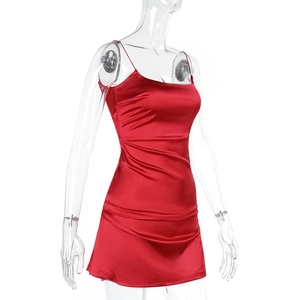 Detail of red satin bodycon dress showing glossy silk fabric and thin shoulder straps
