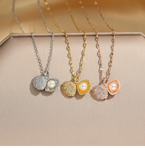 Detail view of openable shell pendant necklace with zircon inlay and internal pearl