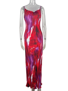 Detail of accordion pleats and abstract red floral print on the slim-fit maxi dress