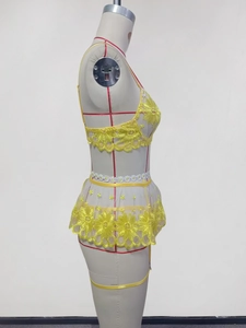 Detailed embroidery of yellow lace lingerie set with sunflower patterns on a dress form