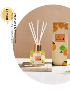 Lemon fragrance oil diffuser set with glass bottle and white fiber reeds on stone tray