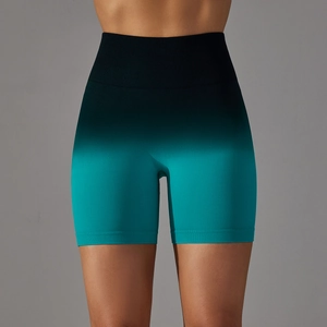 Detail of high waisted seamless yoga shorts with black to teal gradient color and ribbed band