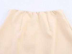 Detailed close-up of light apricot culottes featuring a waist seam and hidden side zipper