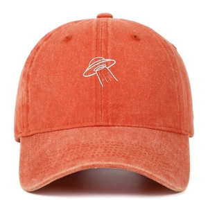 Close-up of high-quality orange washed cotton fabric and white UFO embroidery on cap