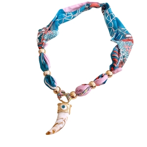 Bohemian silk printed bead necklace with gold accents and ivory-shaped evil eye pendant