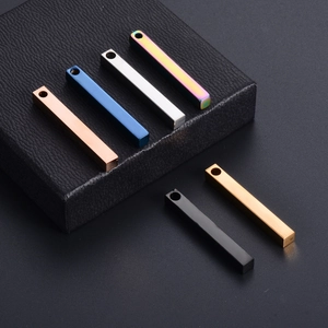 Detailed view of polished rectangular bar pendants in six metallic colors on a black box
