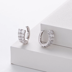 Detail showing double-row sparkling zircon inlays on high-polished silver earrings