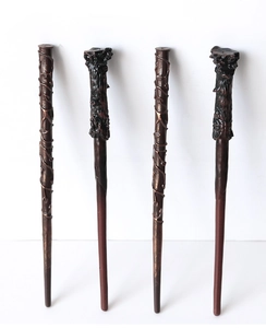 Detailed view of four brown resin magic wands for wizard cosplay costumes