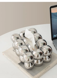 Detail of silver bubble mirror finish ceramic tissue box cover with metallic spherical design