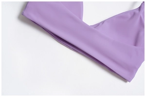 Detail of cross V-neck and smooth elastic fabric on purple sports yoga bra
