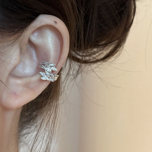 Detailed close-up of a silver wheat ear ear cuff adorned with sparkling white zircons