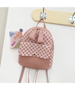 Detailed view of pink mini backpack with floral print hanging on a wall hook