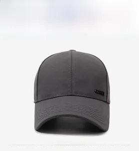 Front view of a dark grey twill cotton baseball cap with a metal logo plate and curved brim
