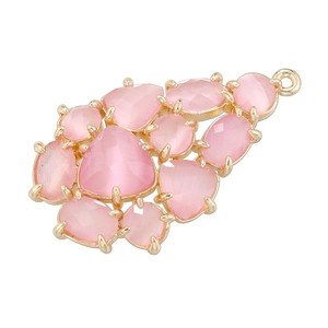 Close-up of a pink glass leaf pendant with a gold-plated copper grape-shaped design