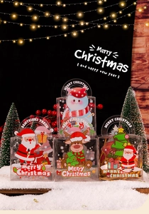 Various Christmas PET gift boxes with Santa and reindeer patterns on artificial snow
