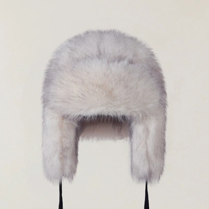 Detail of white and blue gradient faux fur trapper hat with soft earflaps and straps