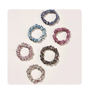 Close-up of 6-piece floral scrunchies set in blue, purple, and pink fabric styles
