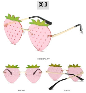 Three-angle views of pink strawberry-shaped sunglasses with golden metal frames