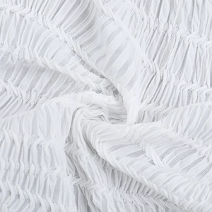 Close-up of white textured crinkle fabric with mesh structure and pleated detail