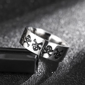 Minimalist 8mm stainless steel ring featuring punk-style black engraved skulls on silver band