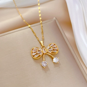 Detailed close-up of golden butterfly necklace pendant with zircon micro-paving for women