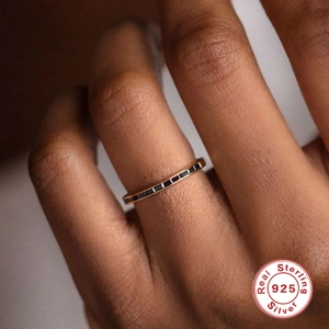 Close-up of S925 sterling silver ring featuring black square-cut gems on gold band