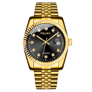 Detailed close-up of a gold steel watch with a black dial and sparkling diamond markers