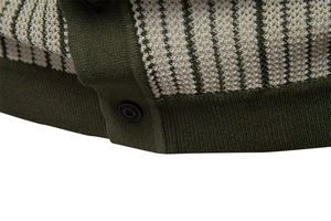 Detailed macro view of the knitted polo hem with green stripes and round black buttons