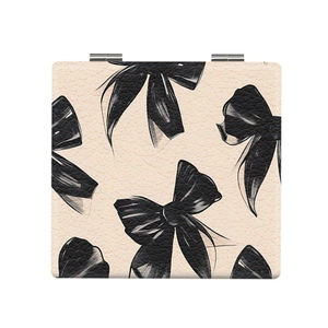 Portable folding makeup mirror with beige leather texture and black bow print design