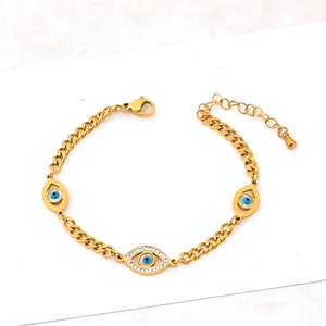 Gold Cuban link bracelet featuring three blue evil eye pendants with sparkling white zircons