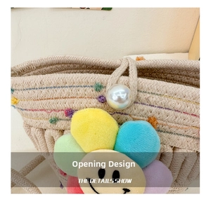 Detail view of the straw bag with a pearl button closure and colorful sunflower accent