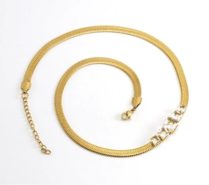 Macro shot of gold plated snake chain necklace with four square clear zircon crystals