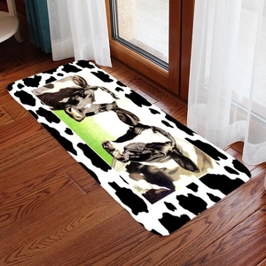 Cow pattern doormat with farm animals print on rustic wood floor background