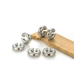 Chunky silver stainless steel ear cuffs with smooth and hammered textures on stone base