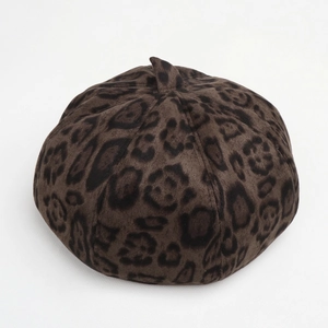 Close-up of leopard print beret in faux suede with a dark brown and black pattern