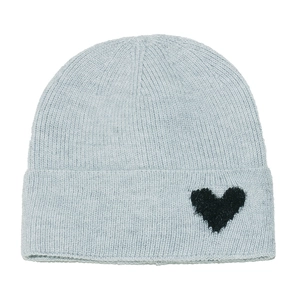 Detailed view of light blue knitted beanie with a black heart pattern and soft texture