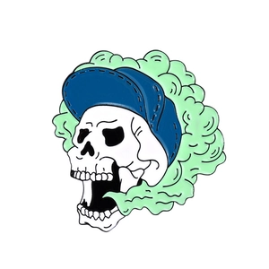 Detailed punk skull enamel pin with blue baseball cap and green smoke effect for accessories