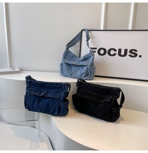 Detailed view of three denim crossbody bags in light blue, dark blue and black colors