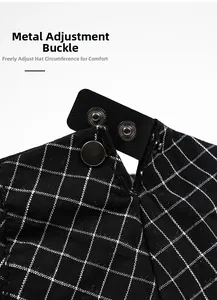Detail of checkered fabric flat cap with adjustable black leather strap and metal snaps