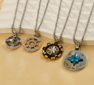 Detail of nautical compass pendants in silver, gold, and black stainless steel finishes
