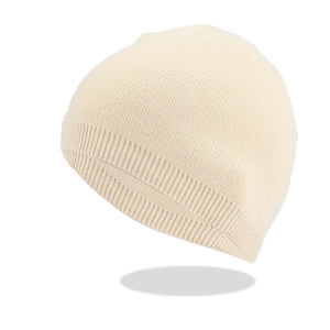 Detailed view of beige knit beanie showing ribbed texture and high-quality wool fabric