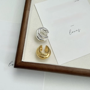 Minimalist multi-layered gold and silver ear cuffs with a sleek geometric wrap design